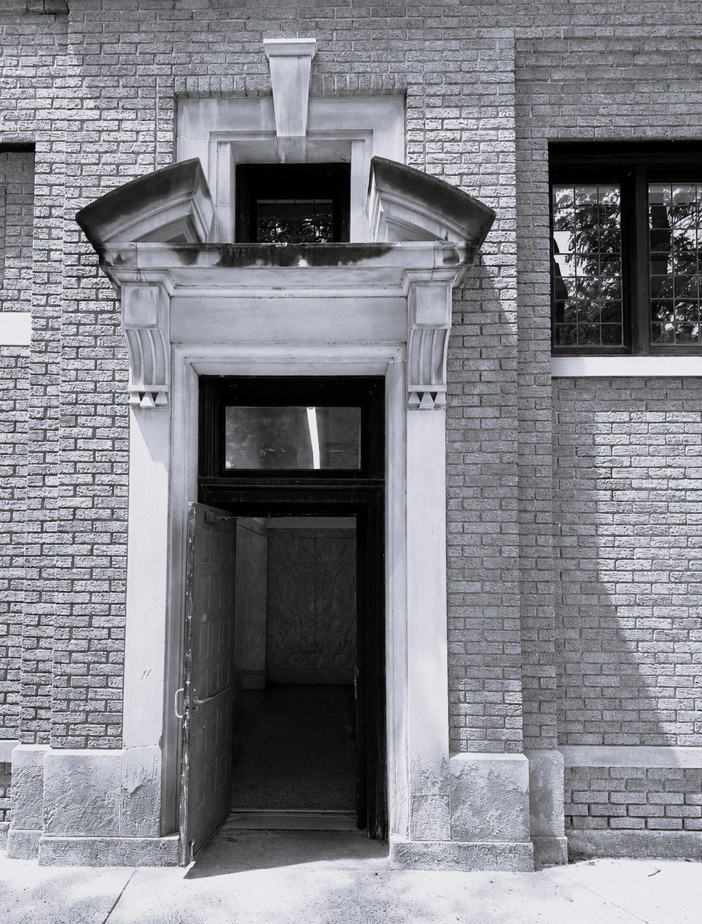 Black and white photo of an ornate stone doorway entrance
