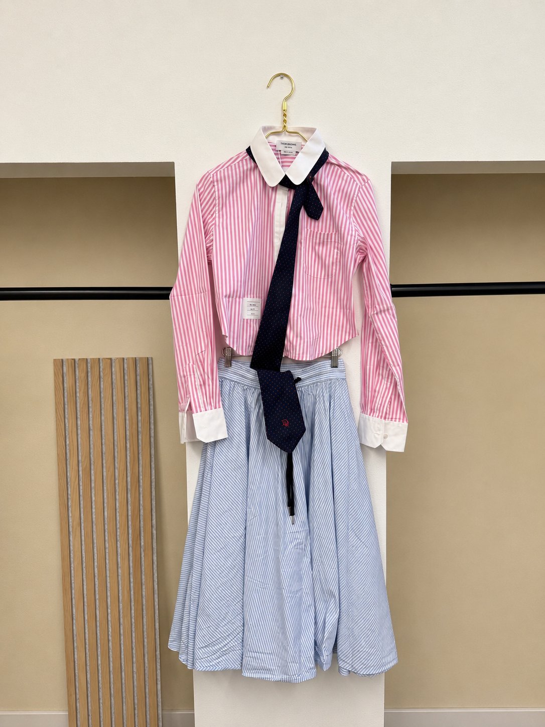 Thom Browne pink striped shirt paired with a Valentino striped skirt and Dior polka dot tie