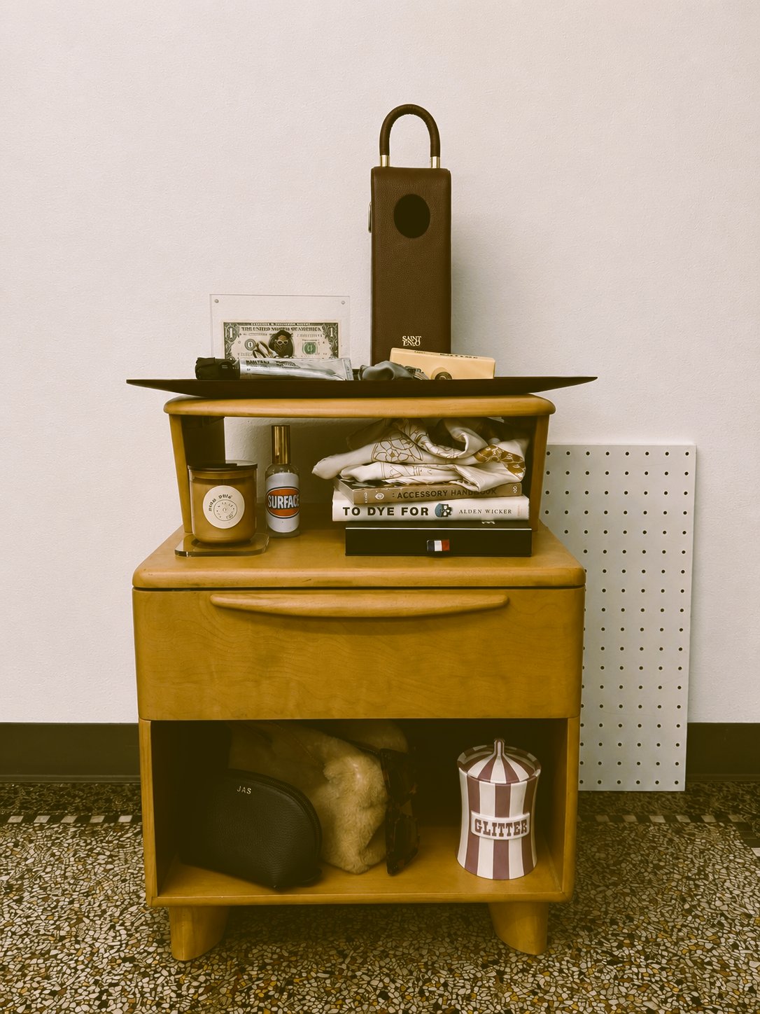 Vintage Heywood-Wakefield nightstand styled with candles, books, and accessories